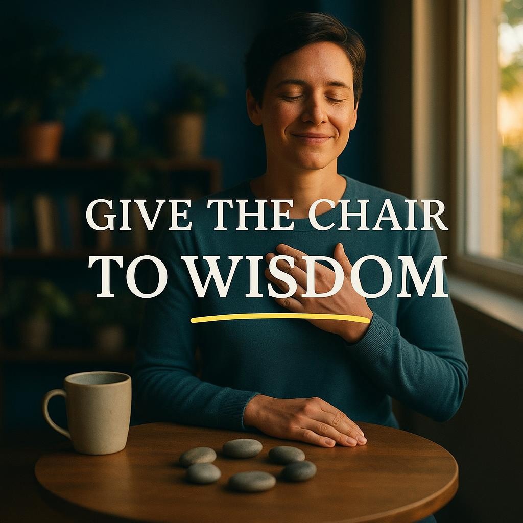 Serene person at a sunlit wooden table with hand over heart, soft teal blurred background and shallow depth of field, large central text reading Give the Chair to Wisdom, reflecting the politics of spirituality, chakra wisdom, and the Inner Cabinet practice.